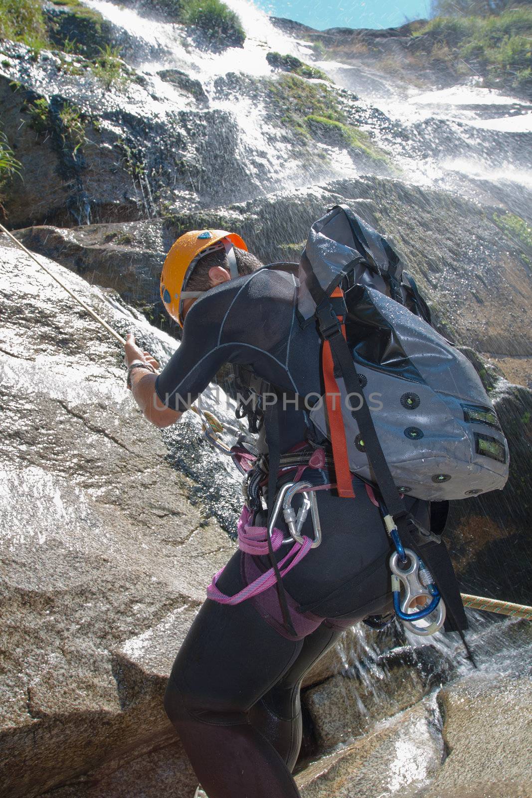 Men descending waterfall by PauloResende