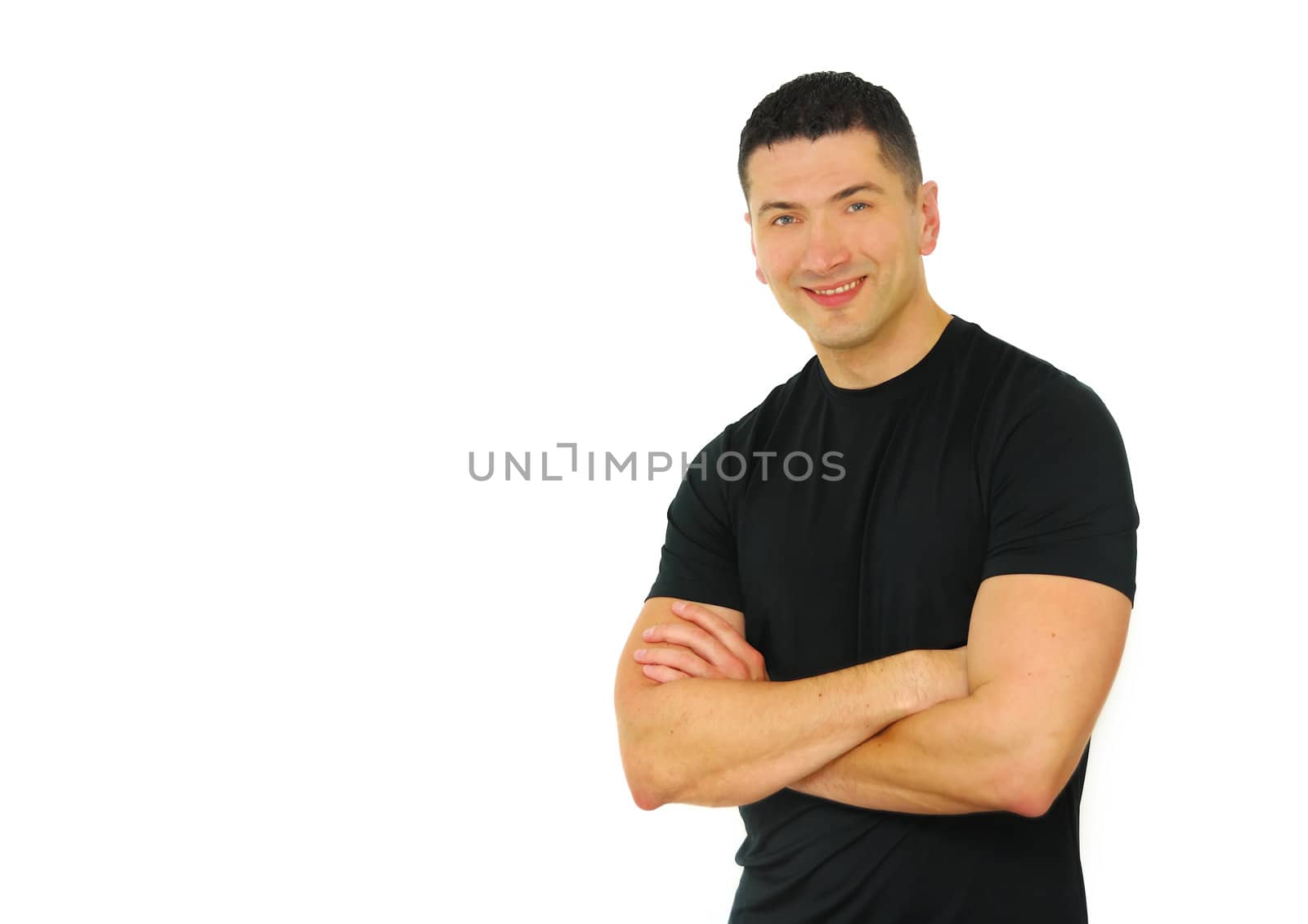 A portrait of a smiling Caucasian athletic man with his arms crossed isolated over white background.