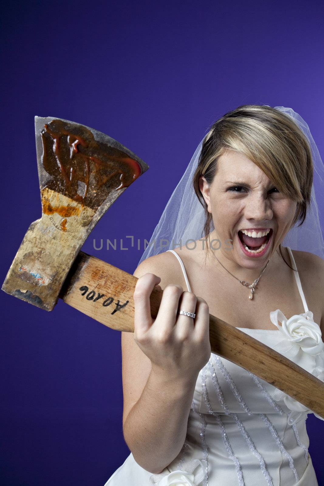 angry young bride with an axe on a dark blue background