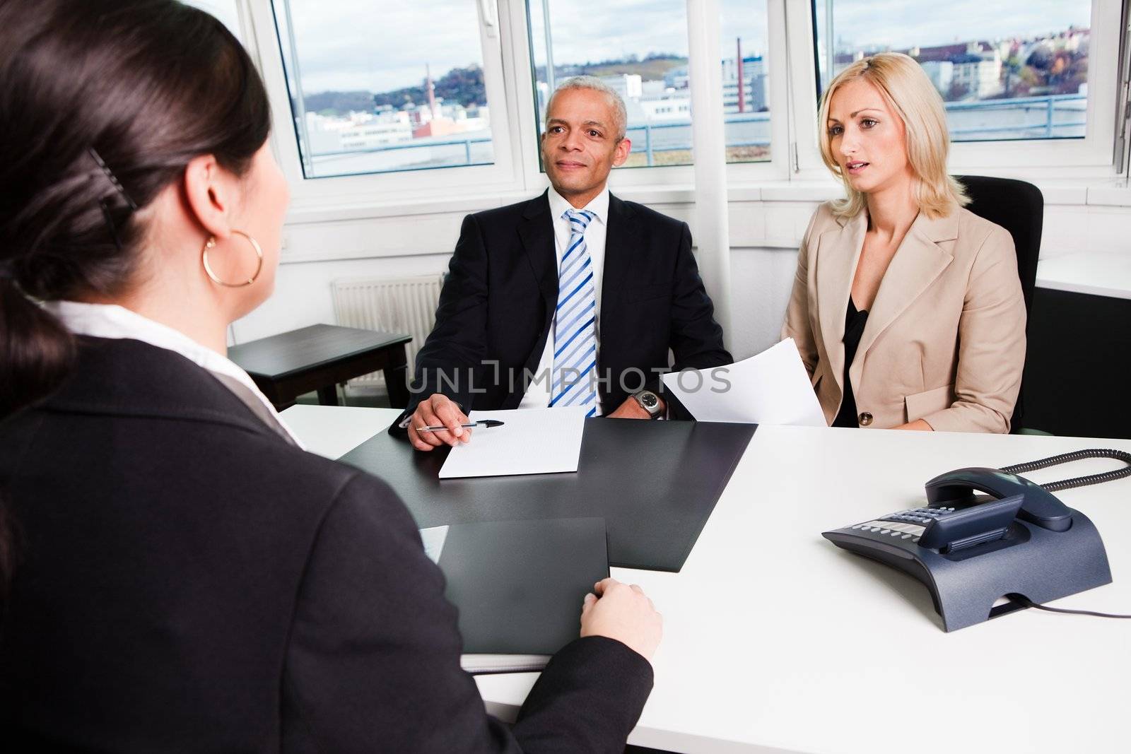Three businesspeople at an interview in the office