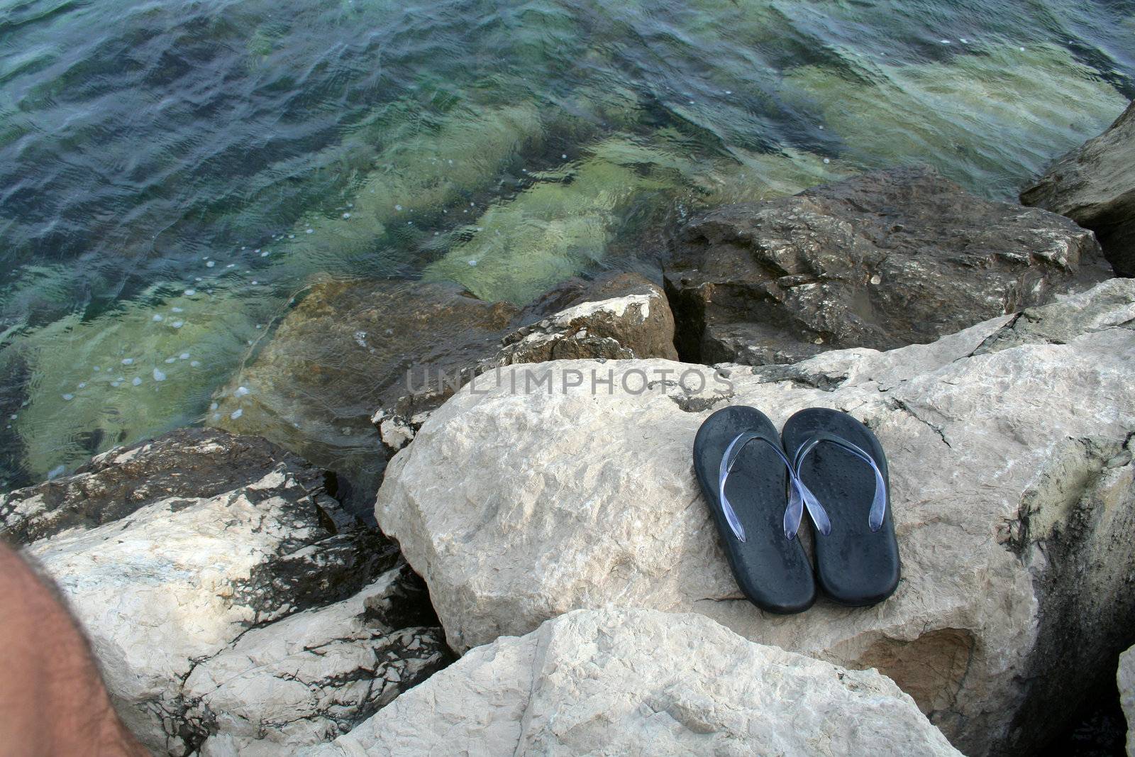 pair of sandals on the rocky coast in Croatia