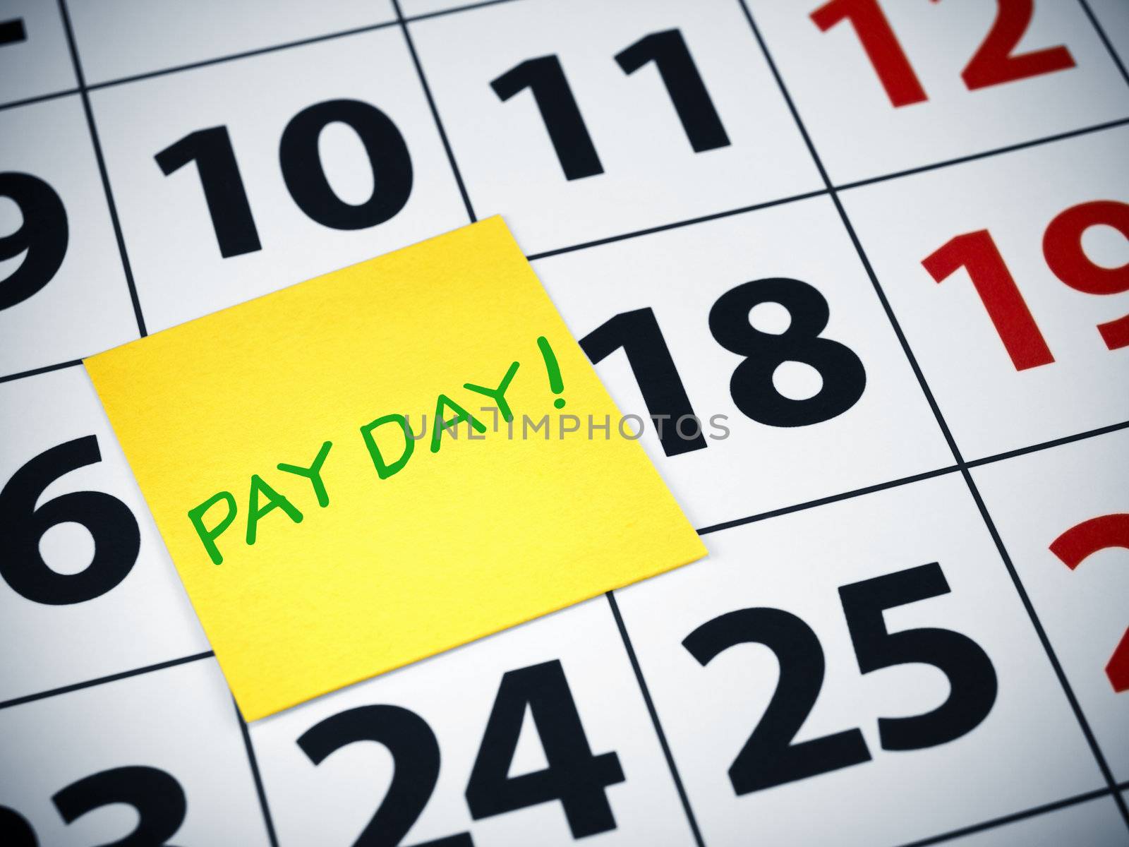 Pay day written on a sticky note on a calendar.