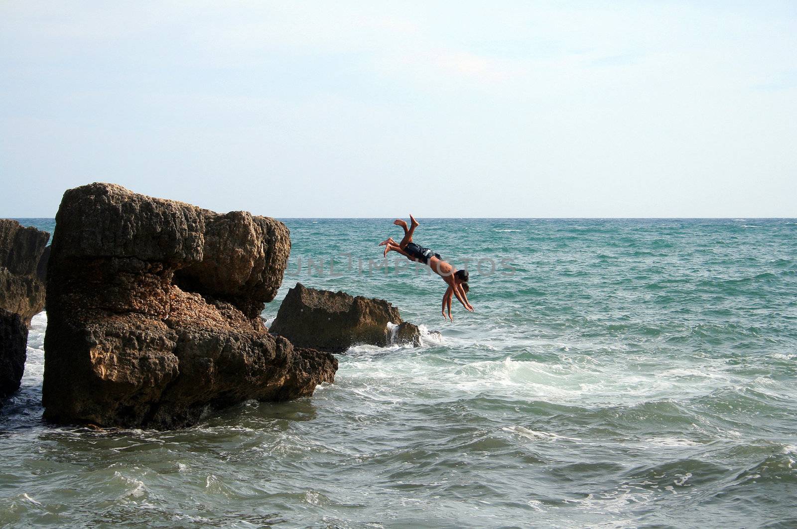 two men jumping into the water in Croatia