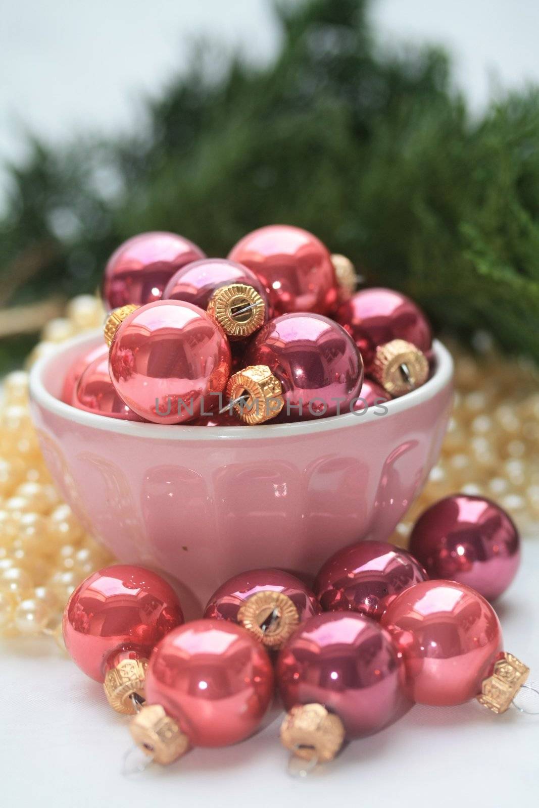 A bowl with small pink christmas balls