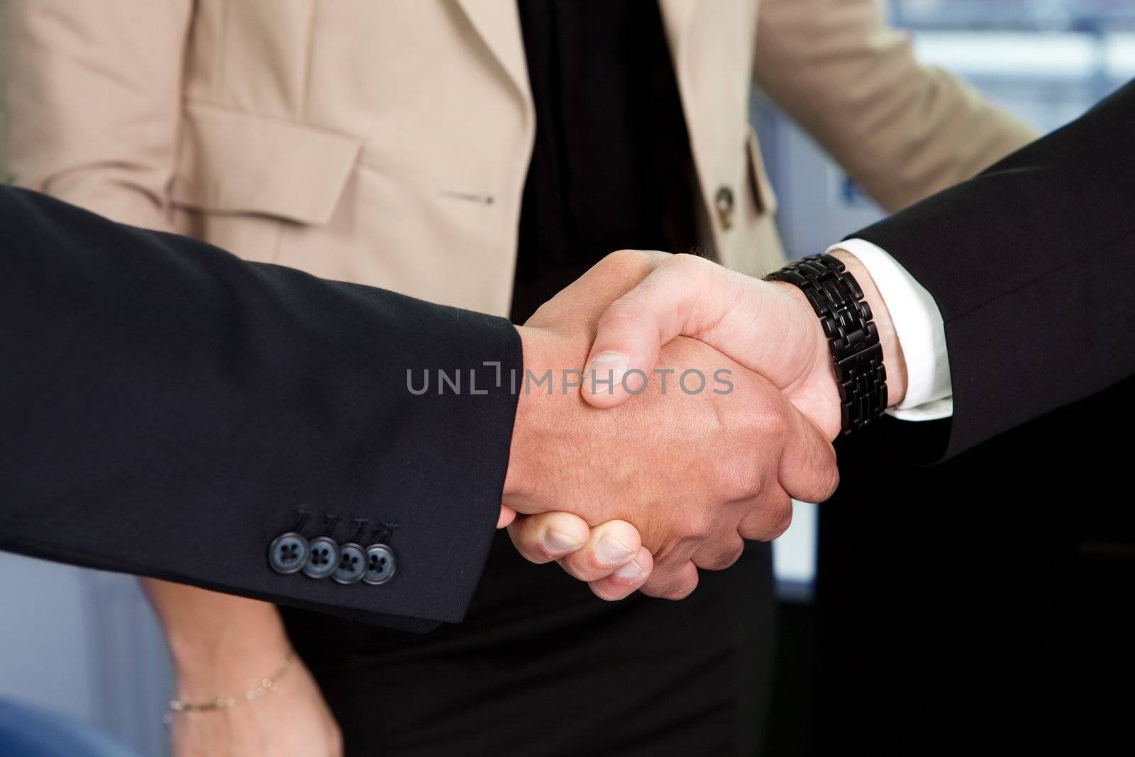 Business handshake over the deal by AndreyPopov