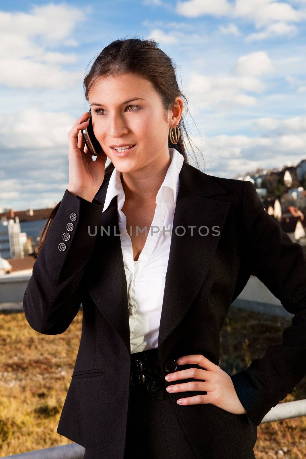 Portrait of beautiful businesswoman talking on cellphone outside