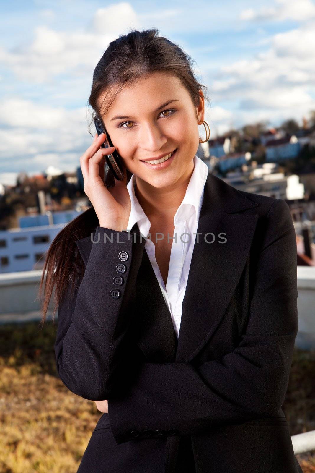 Portrait of beautiful businesswoman talking on cellphone outside