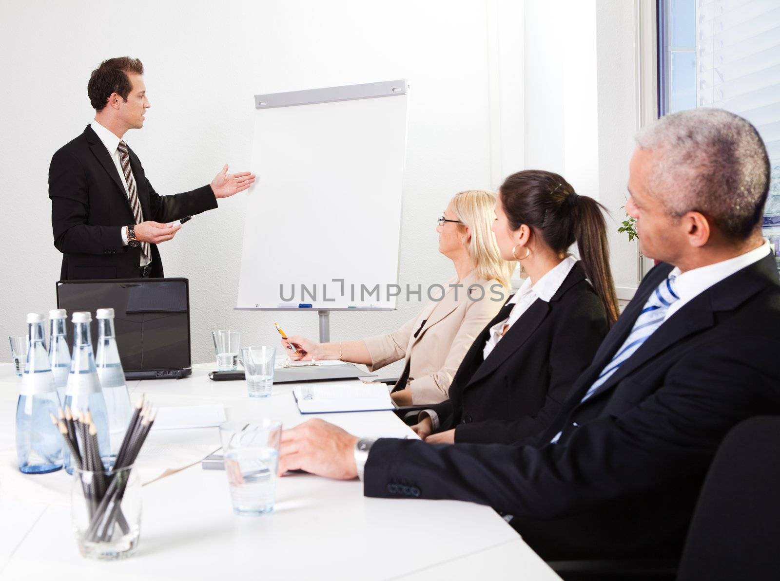 Businessman giving a presentation by AndreyPopov