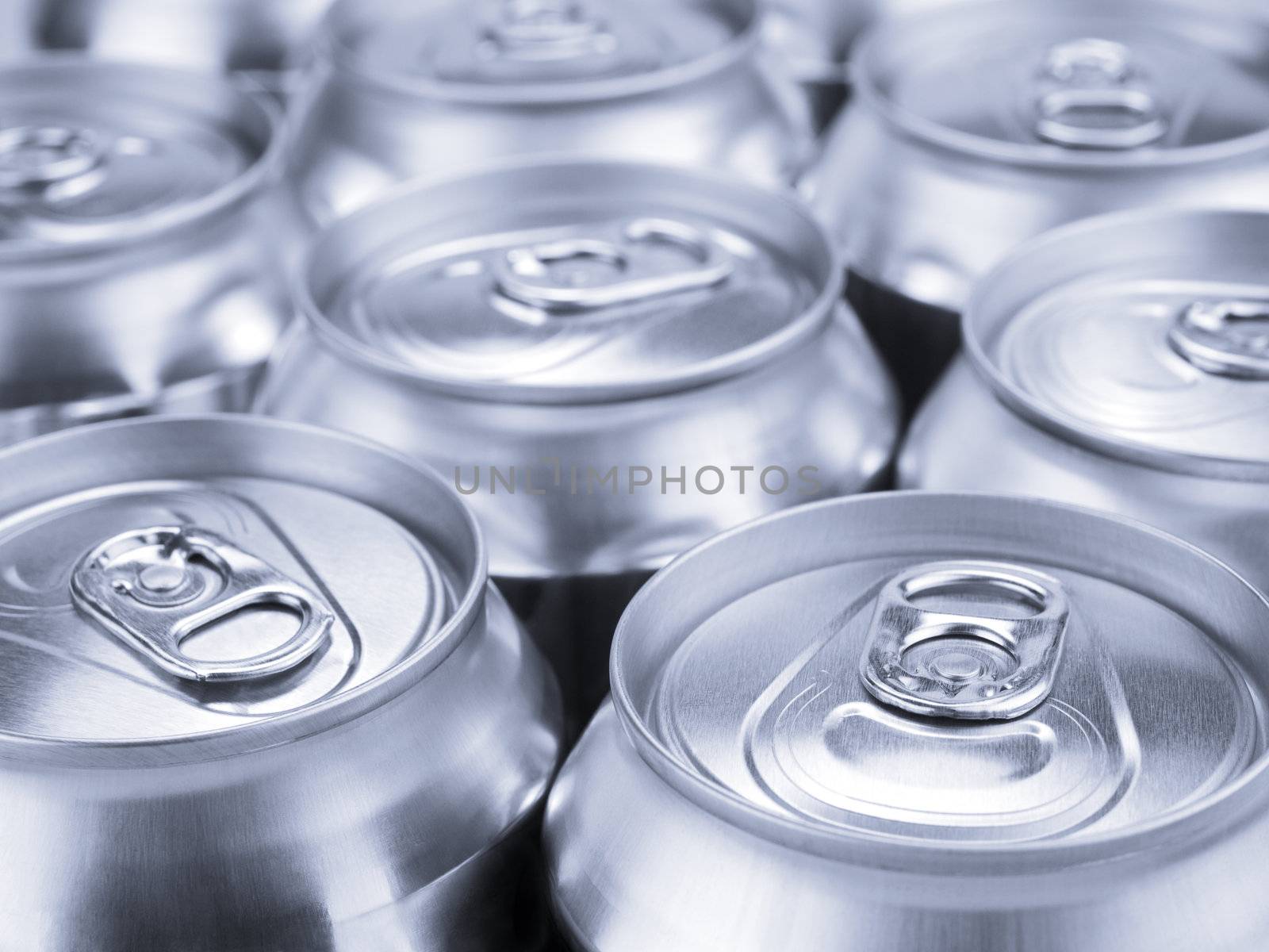 Several soda or beer cans. Shallow depth of field.