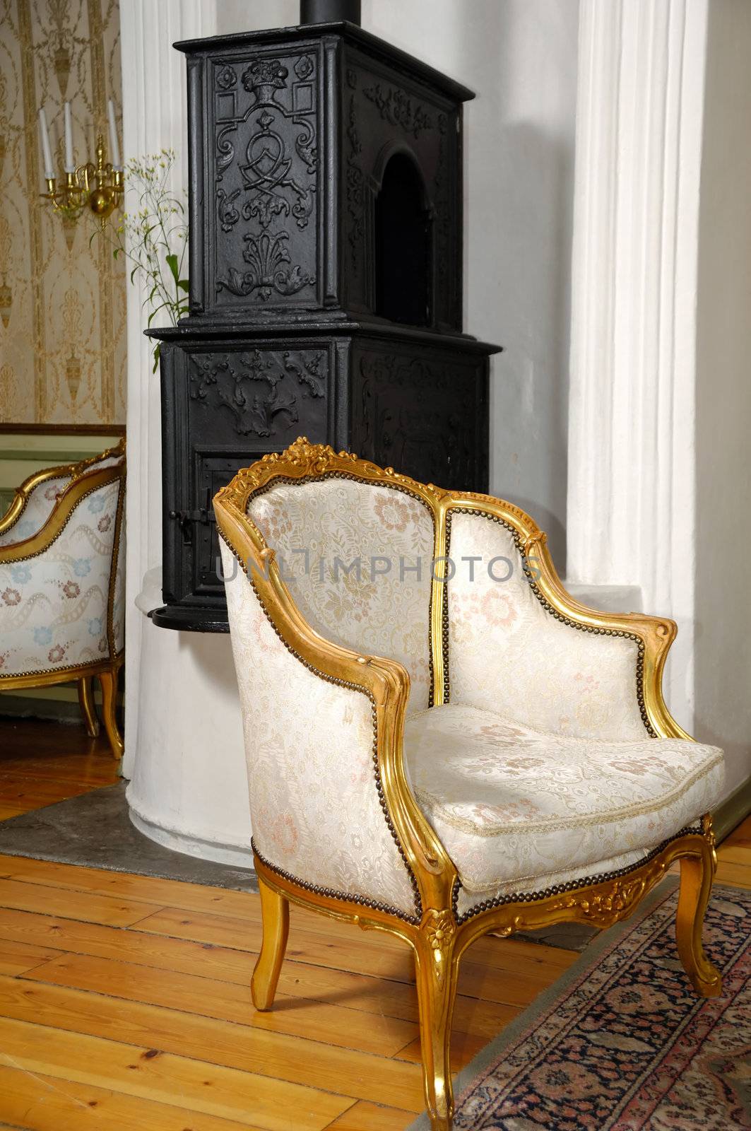 Elegant armchair and fireplace in the background