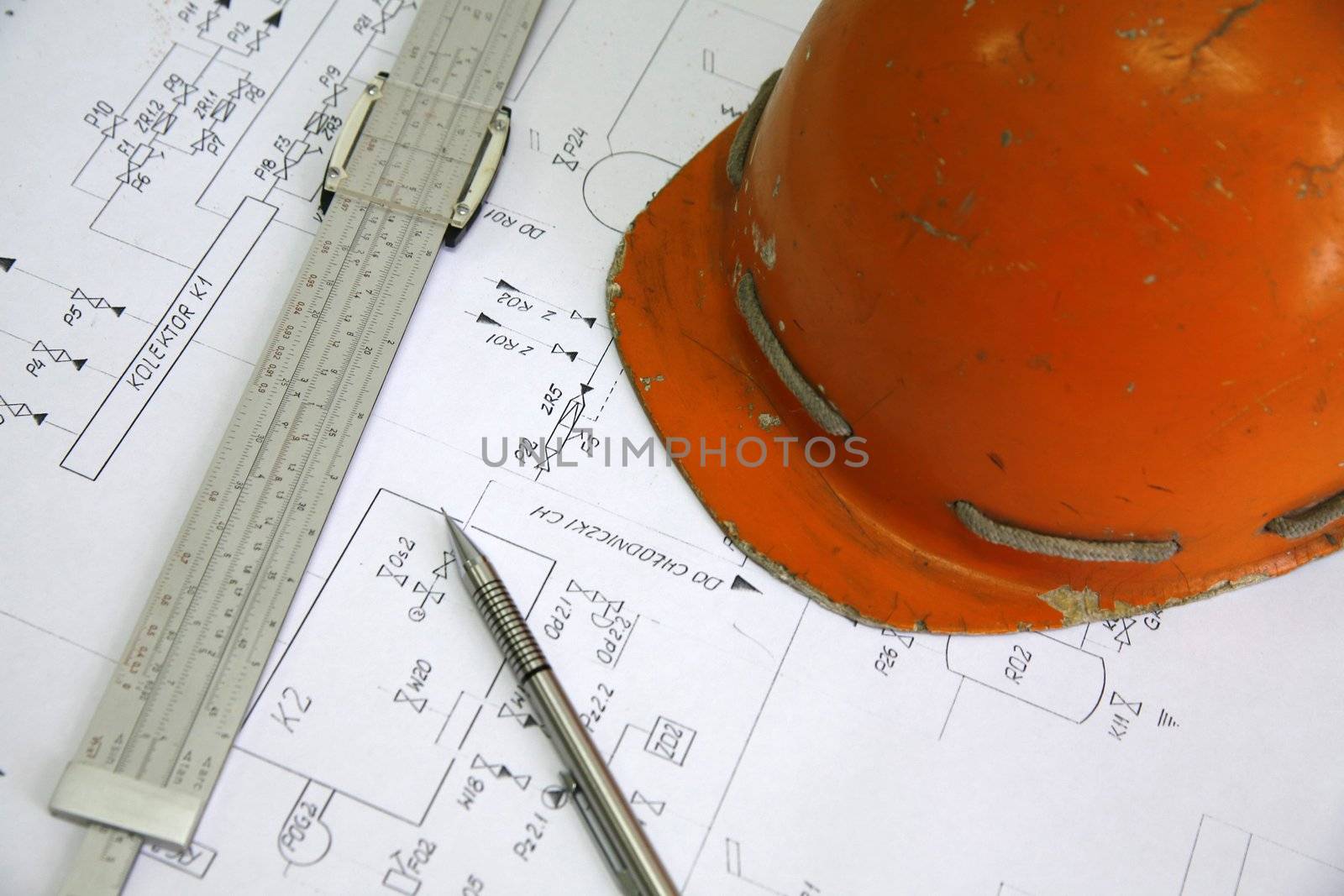pencil, calliper and helmet on electrical scheme