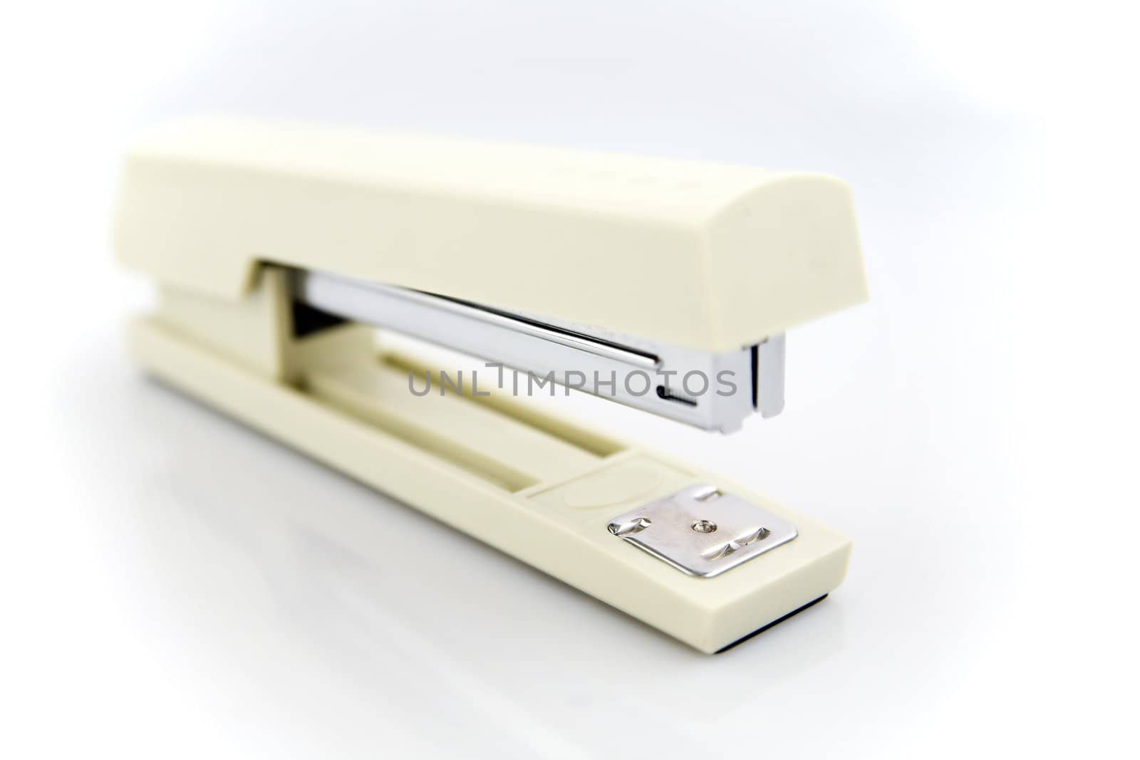 cream stapler isolated on white background