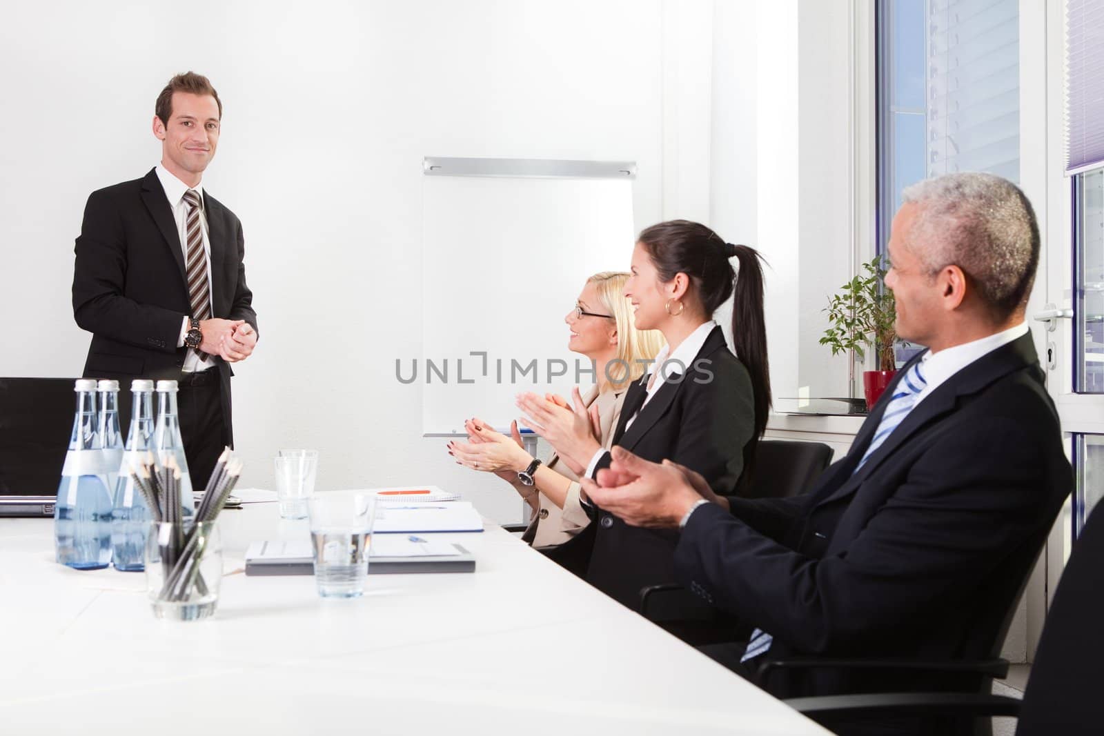 Business team applauding after successful presentation at the meeting