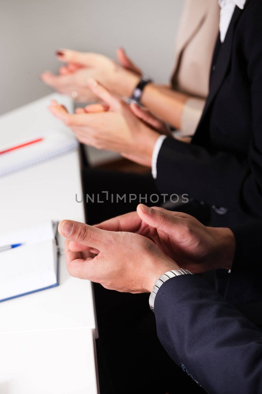 Business team applauding after successful presentation. Close-up shot of hands