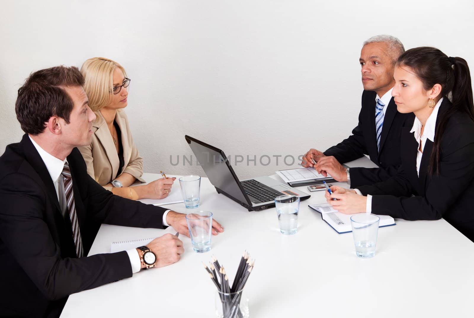 Four business people discussing in the meeting