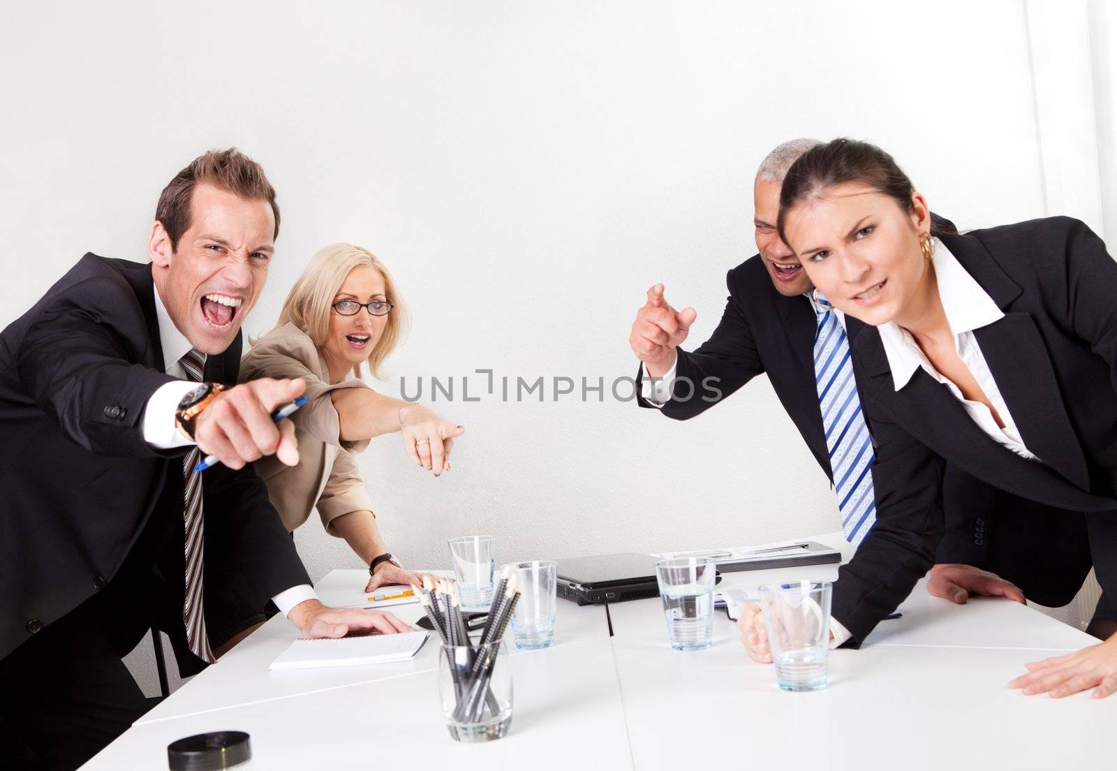 Four angry business people screaming at camera