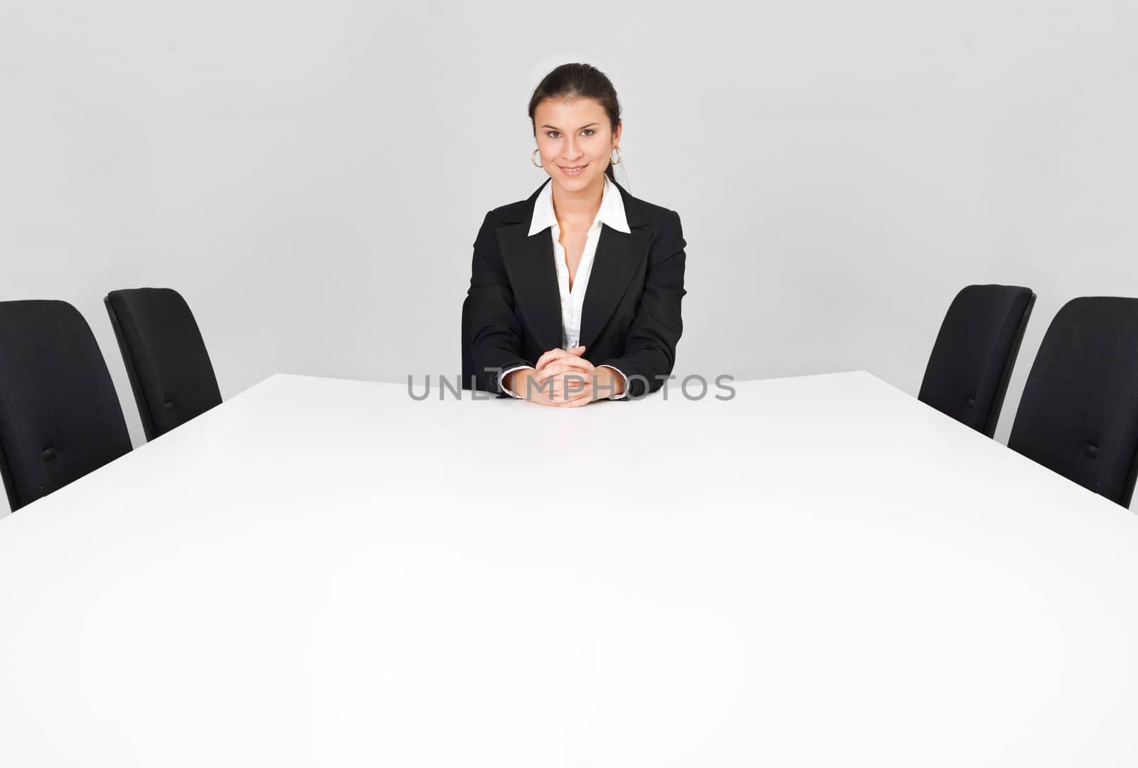 Businesswoman sitting alone in the empty boardroom