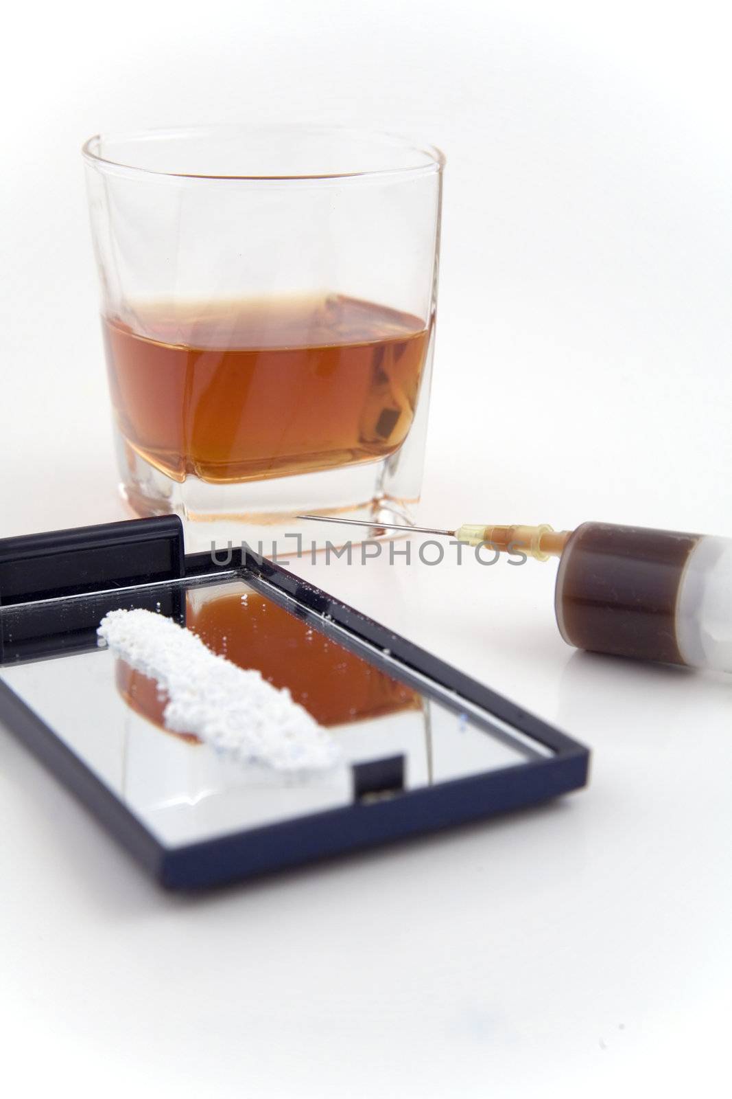 syringe, cocaine and a glass of whiskey