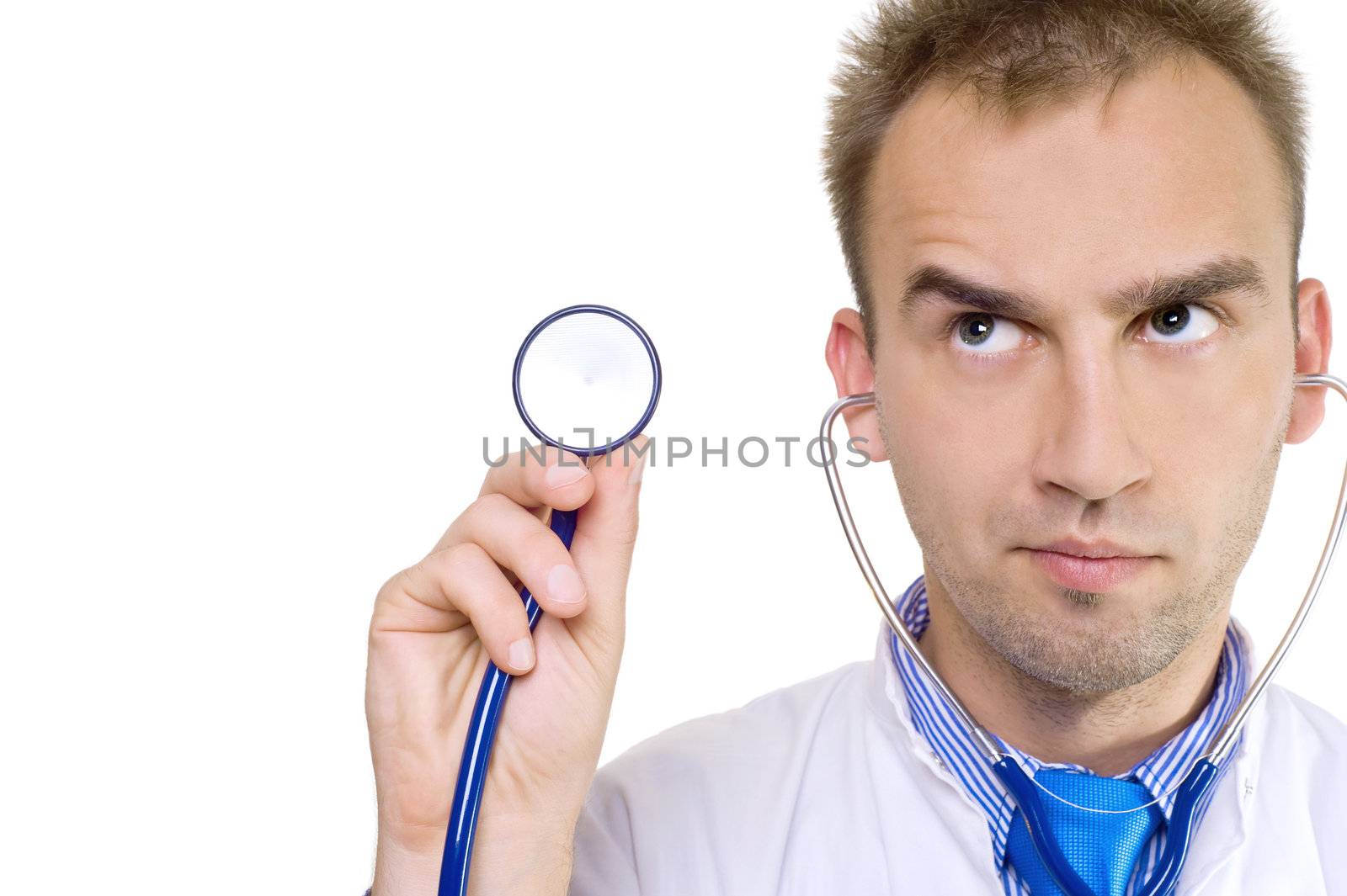 concerned young male doctor holding stethoscope in hand