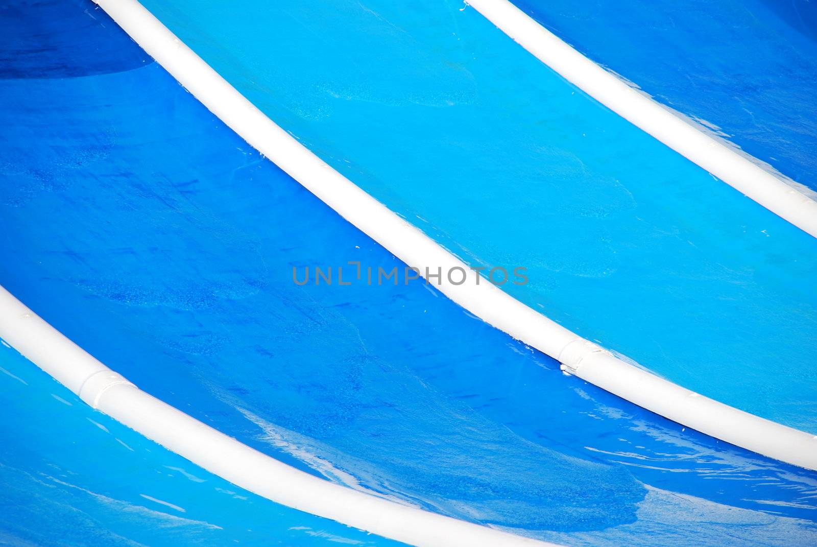 close up photo of a blue waterslide (background)