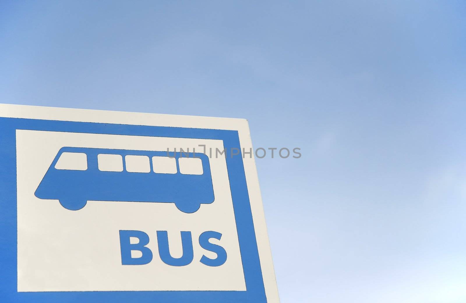 bus stop sign over the blue sky