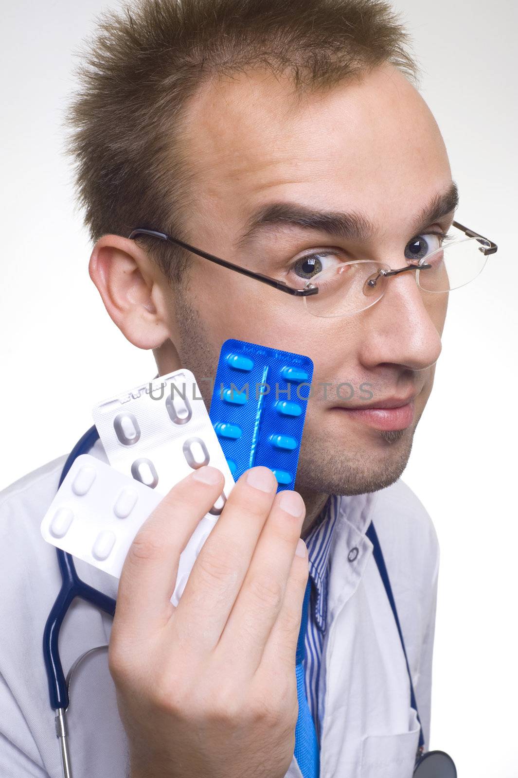 young male doctor holding blisters of pills