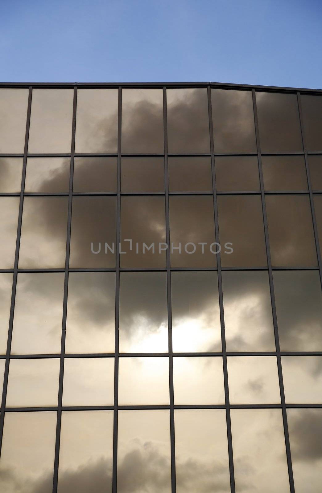 glass wall of modern trade center over the blue sky