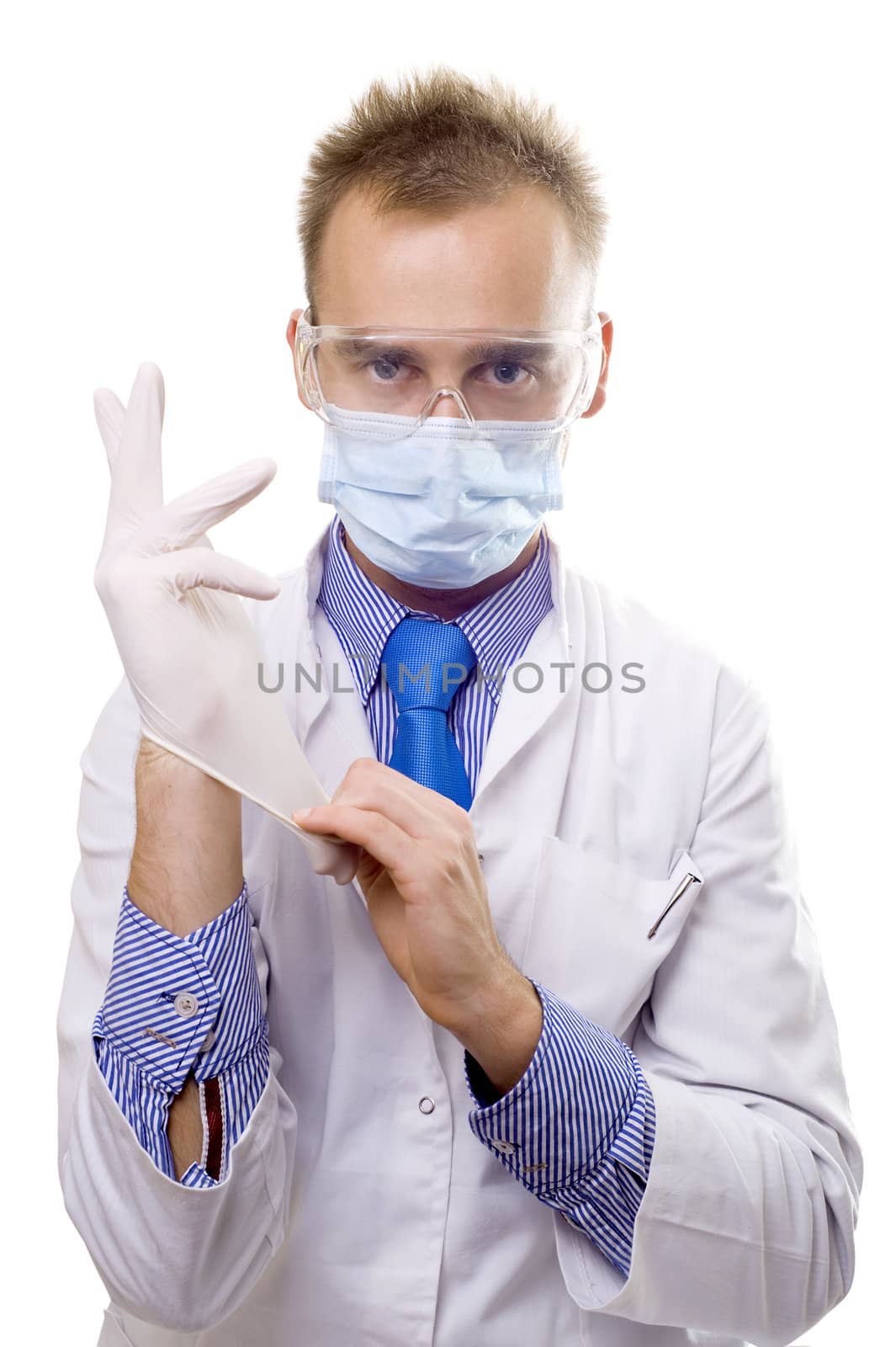 man in mask pulling on medical glove