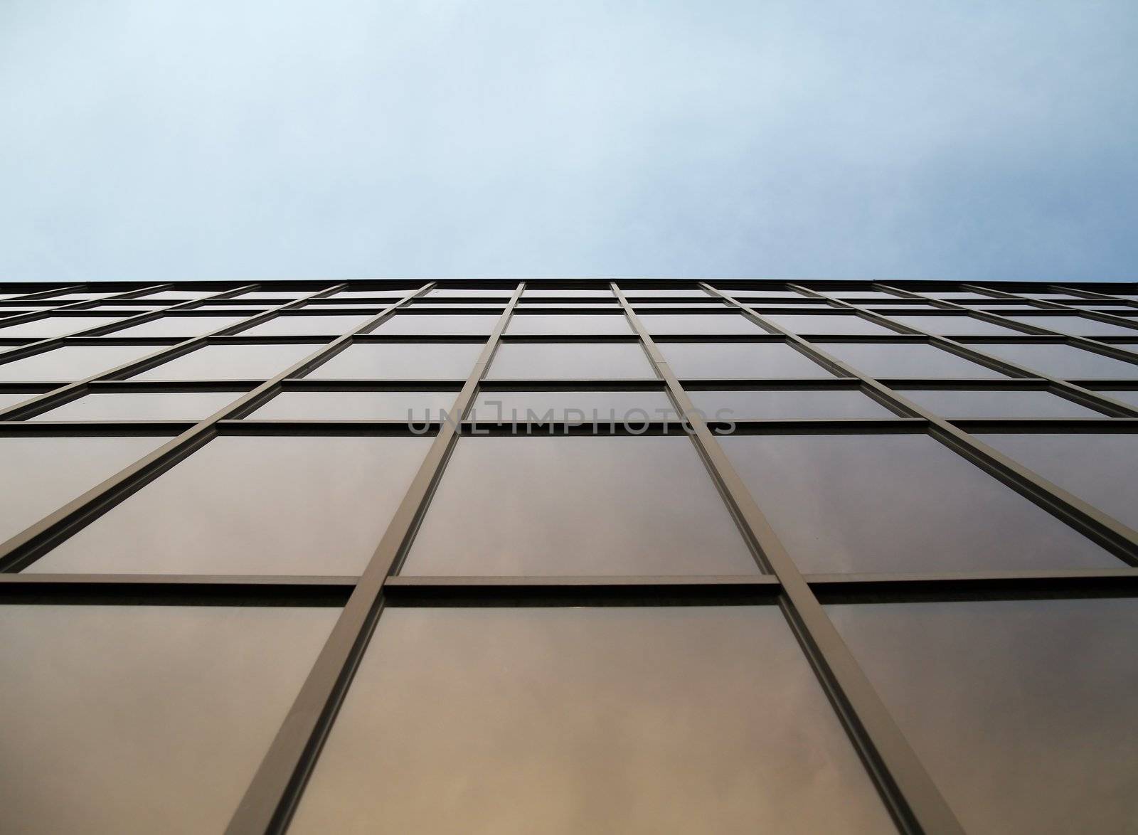 glass wall of modern trade center over the blue sky