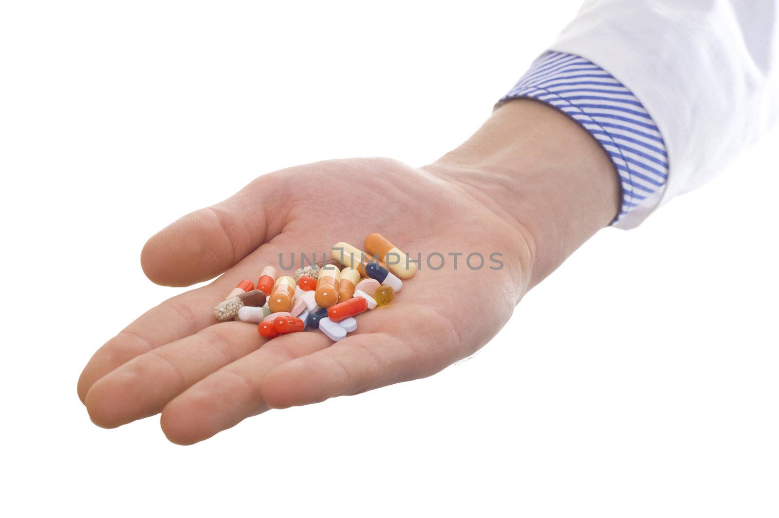 man's hand holding plenty of colorful pills