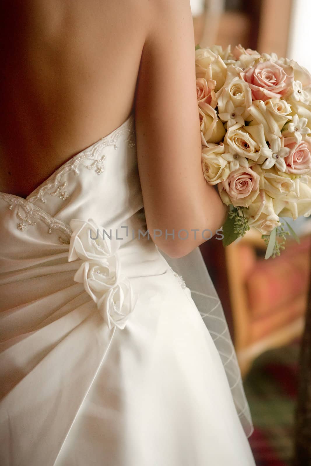 A back view of a bride with her bouquet