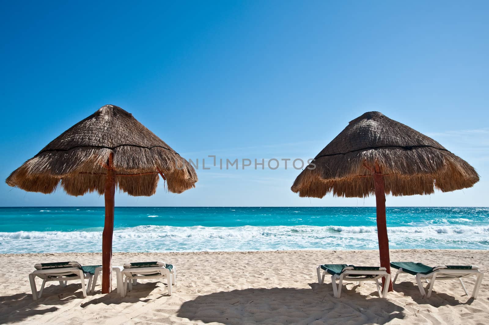 Two sun umbrellas by the beach