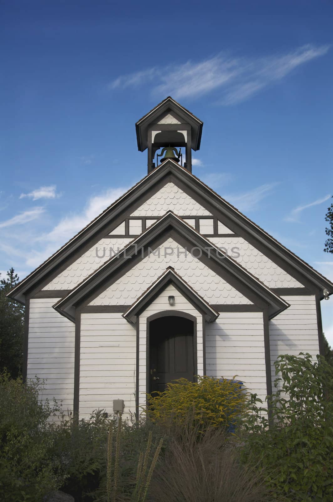 An old church building stands against a blue, Colorado sky.
