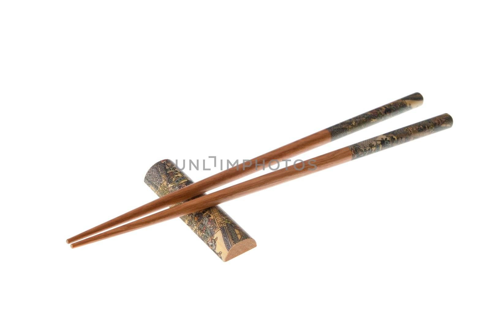 Two wooden chopsticks with holder. Sticks and holder are decorated with temple theme ornamentation. Isolated on white