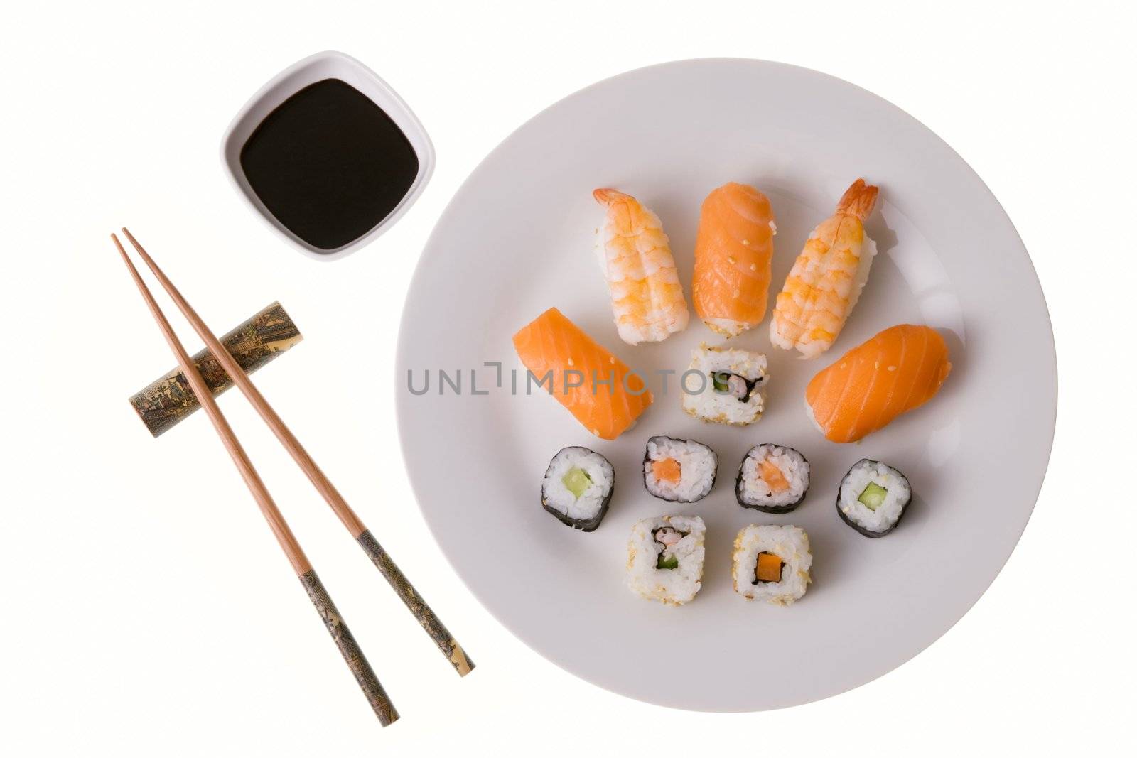 Variety of sushi rolls: Nigiri Sushi salmon and king prawn; California rolls and Makizushi. Soy sauce and chopsticks. Isolated on white