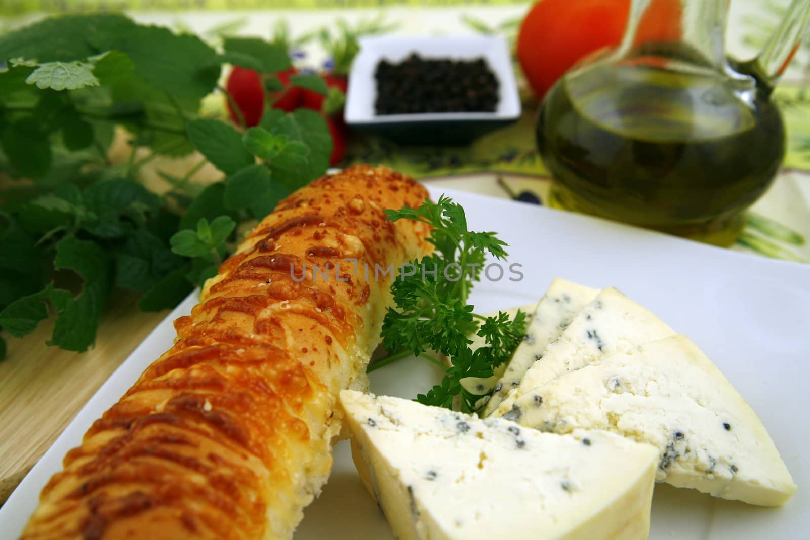 french cheese and bread with cheese, wine, some herbs, nuts and pepper