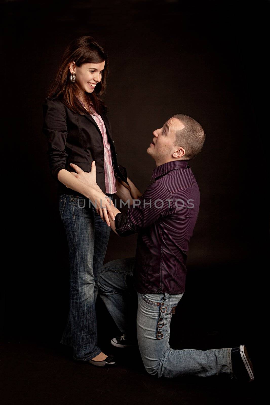 Men begging pardon from a girlfriend. Studio shot