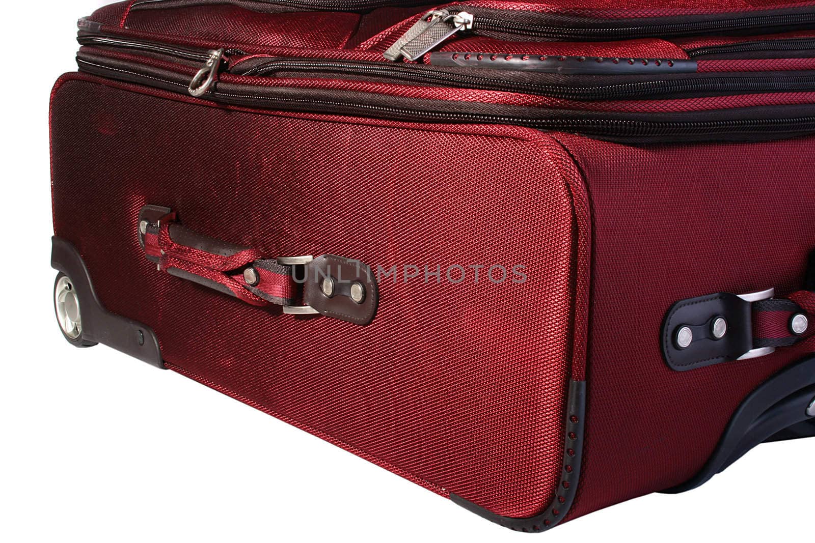 The big red suitcase on castors, is convenient on travel.