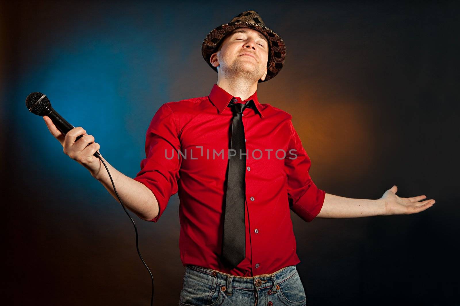 Portrait of proud young singer. Studio shot