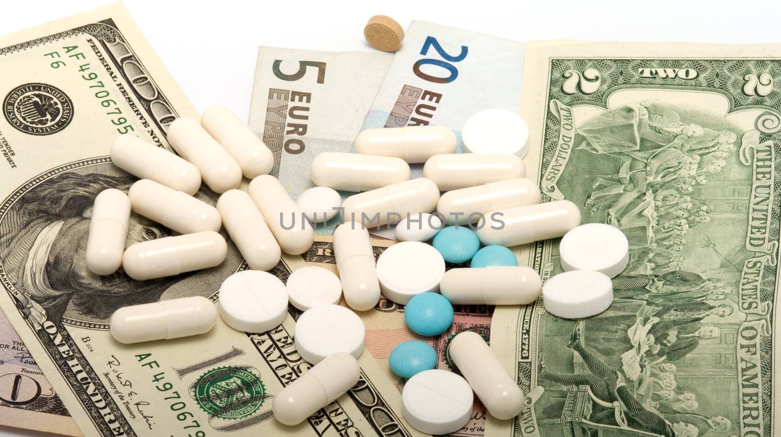 Capsules and pills on the notes of dollars and euro.