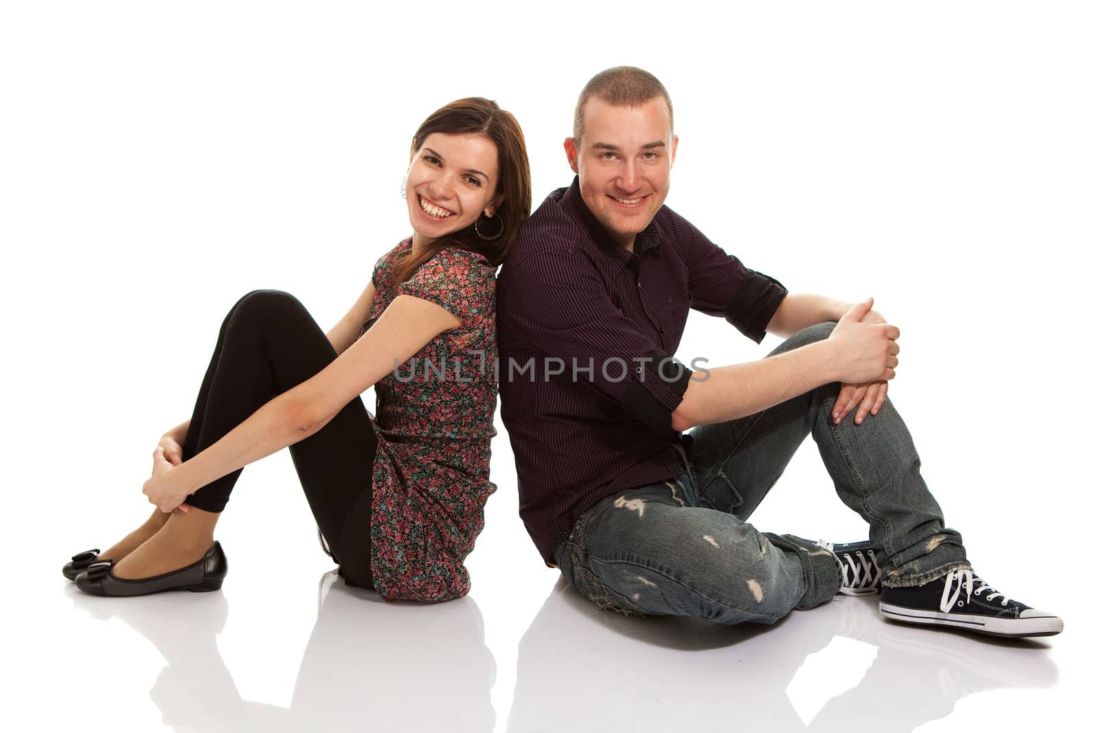 Happy young couple together. Isolated on white