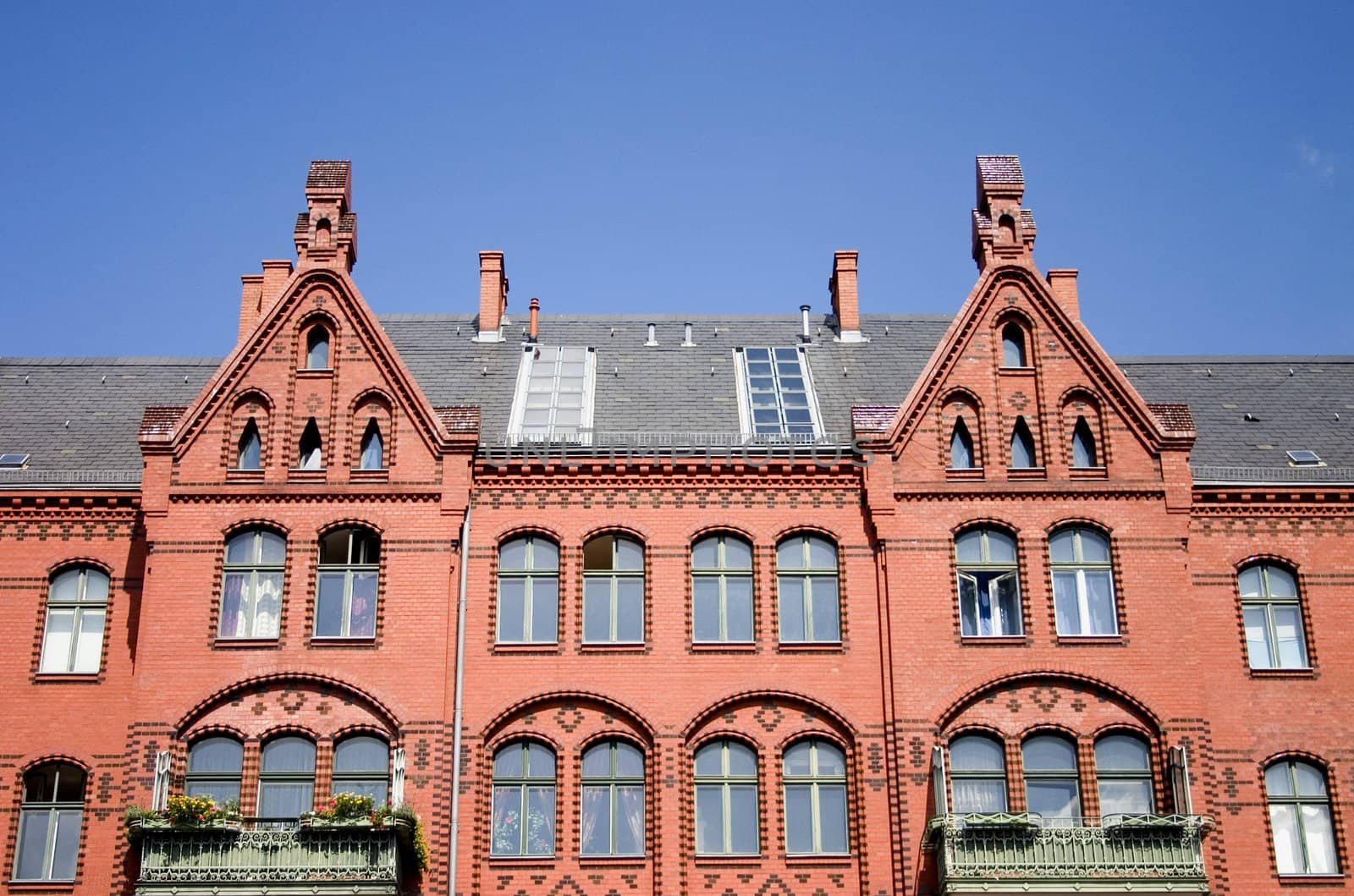 Old architecture of Berlin.
The old red brick house under the dark blue sky.