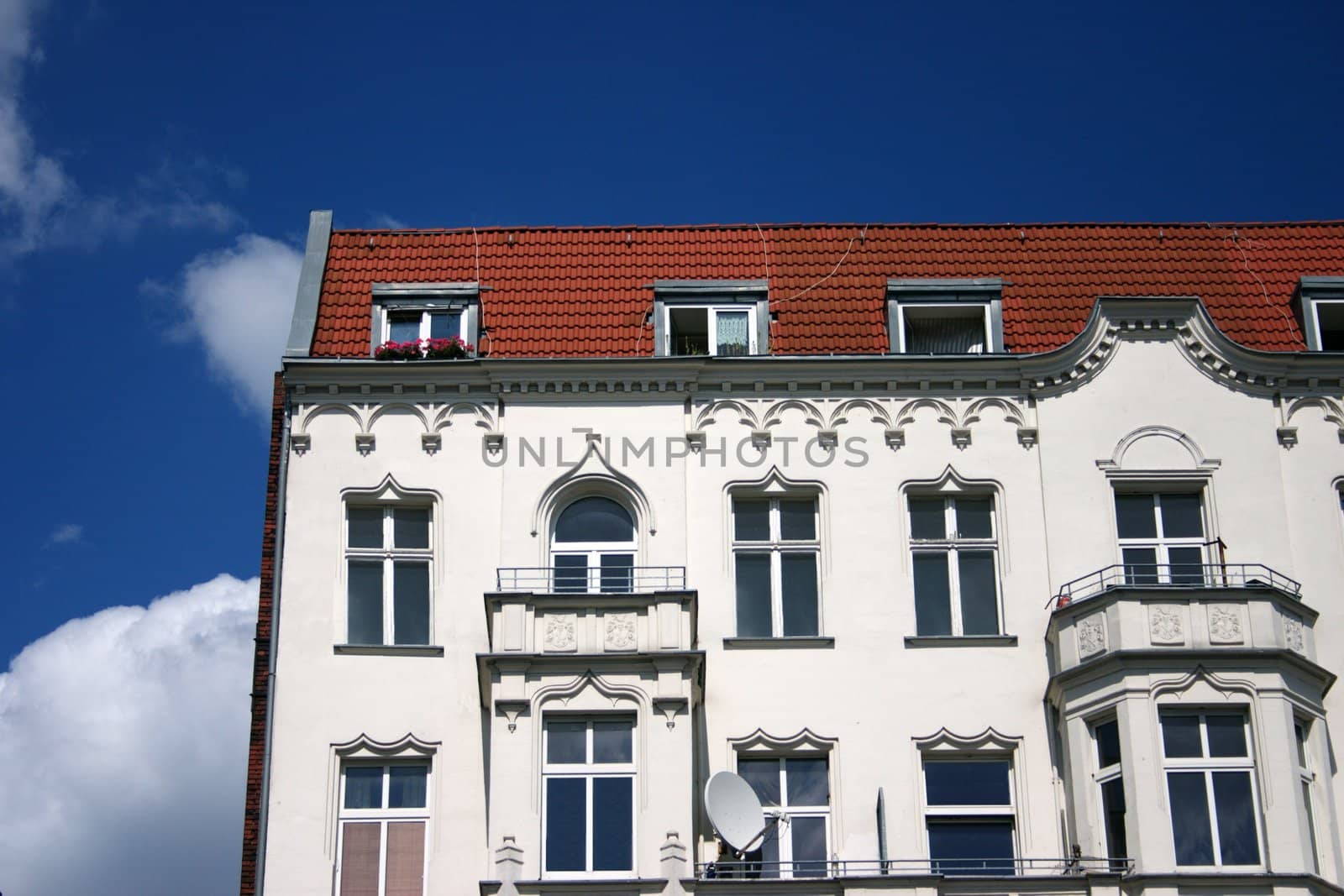 The old white house, architectural moulding of a facade outside and with balconies