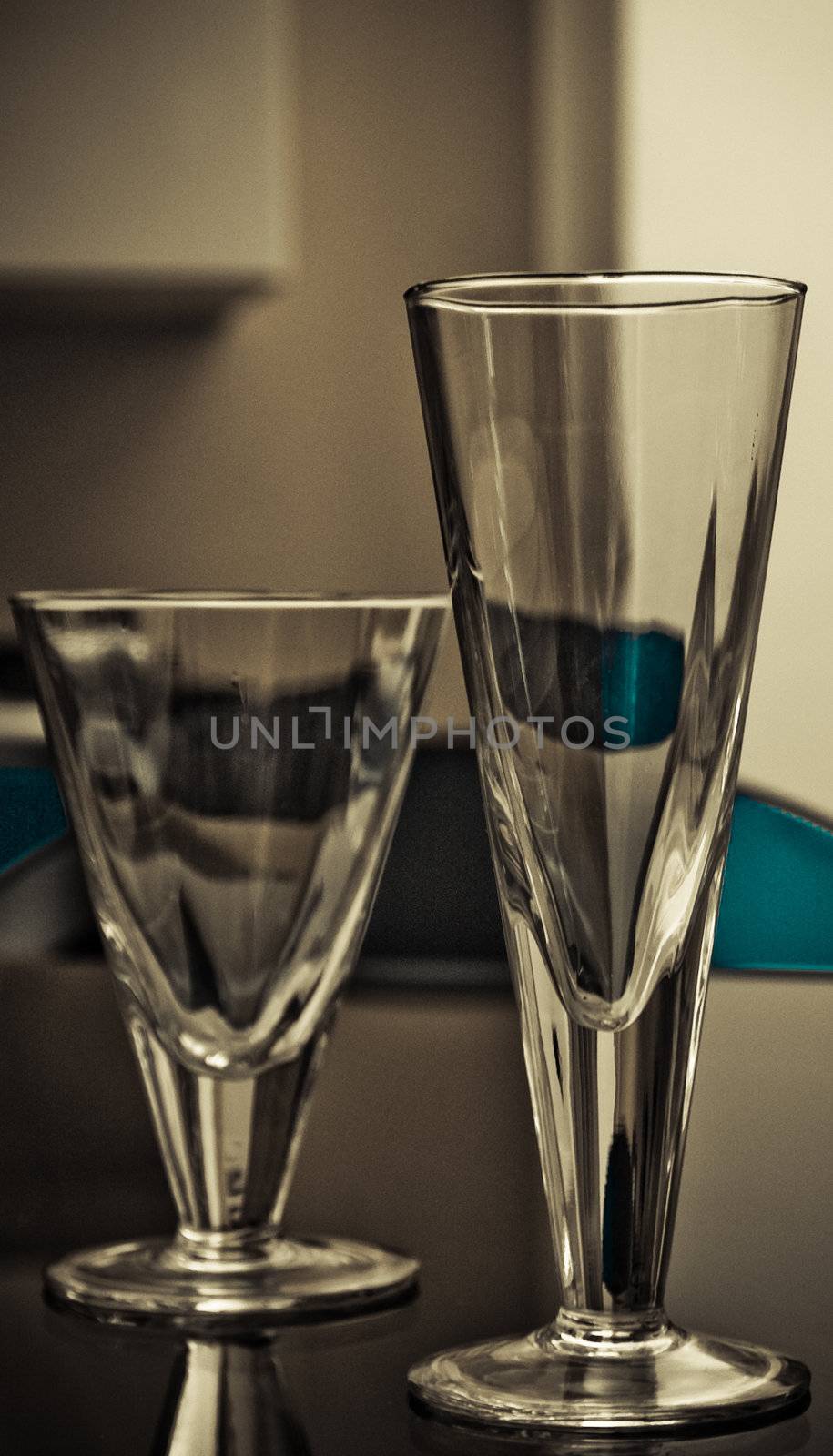 Modern glasses and plates on the glass table with light soft