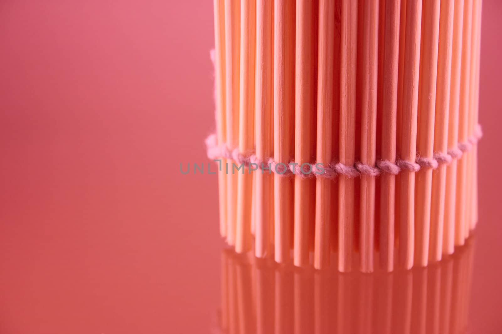 Bamboo napkin in a roll put vertically and removed close up with use of the red filter