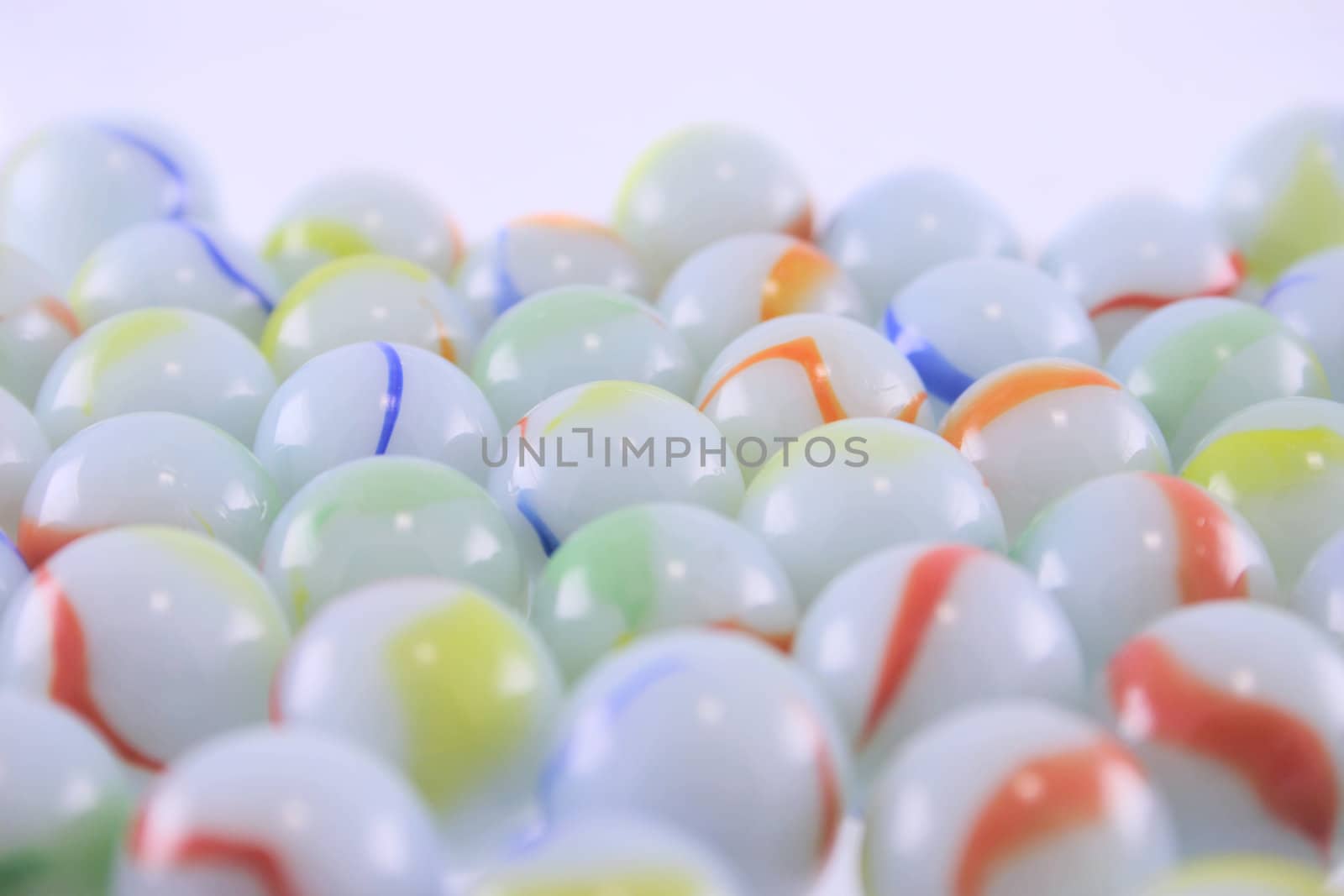 Heap of ceramic multi-coloured balls removed close up