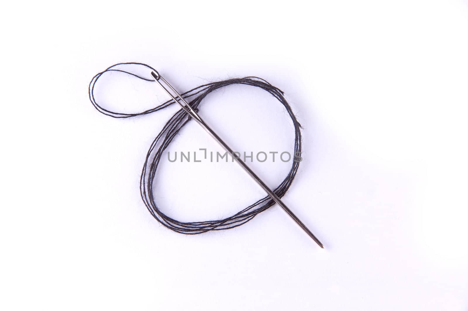 A needle with black thread, isolated on white