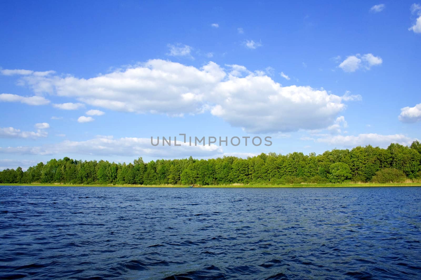 blue sky with white clouds over blue water (Poland)