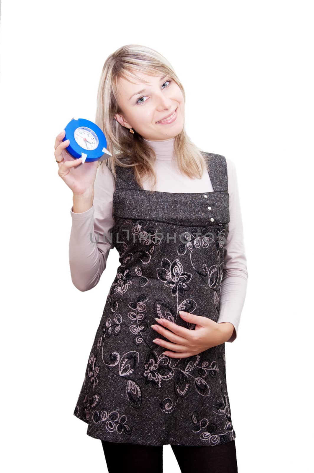 Pregnant woman holding clock over white