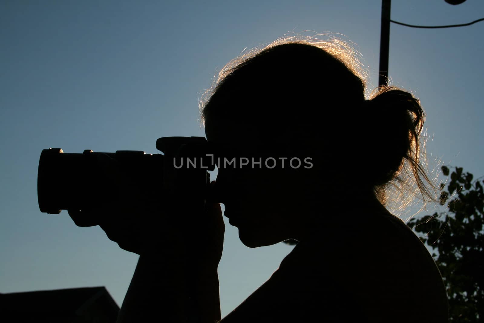 beautifull woman taking picture during sunset